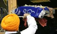 The Guru Granth Sahib is carried into the Gurdwara
